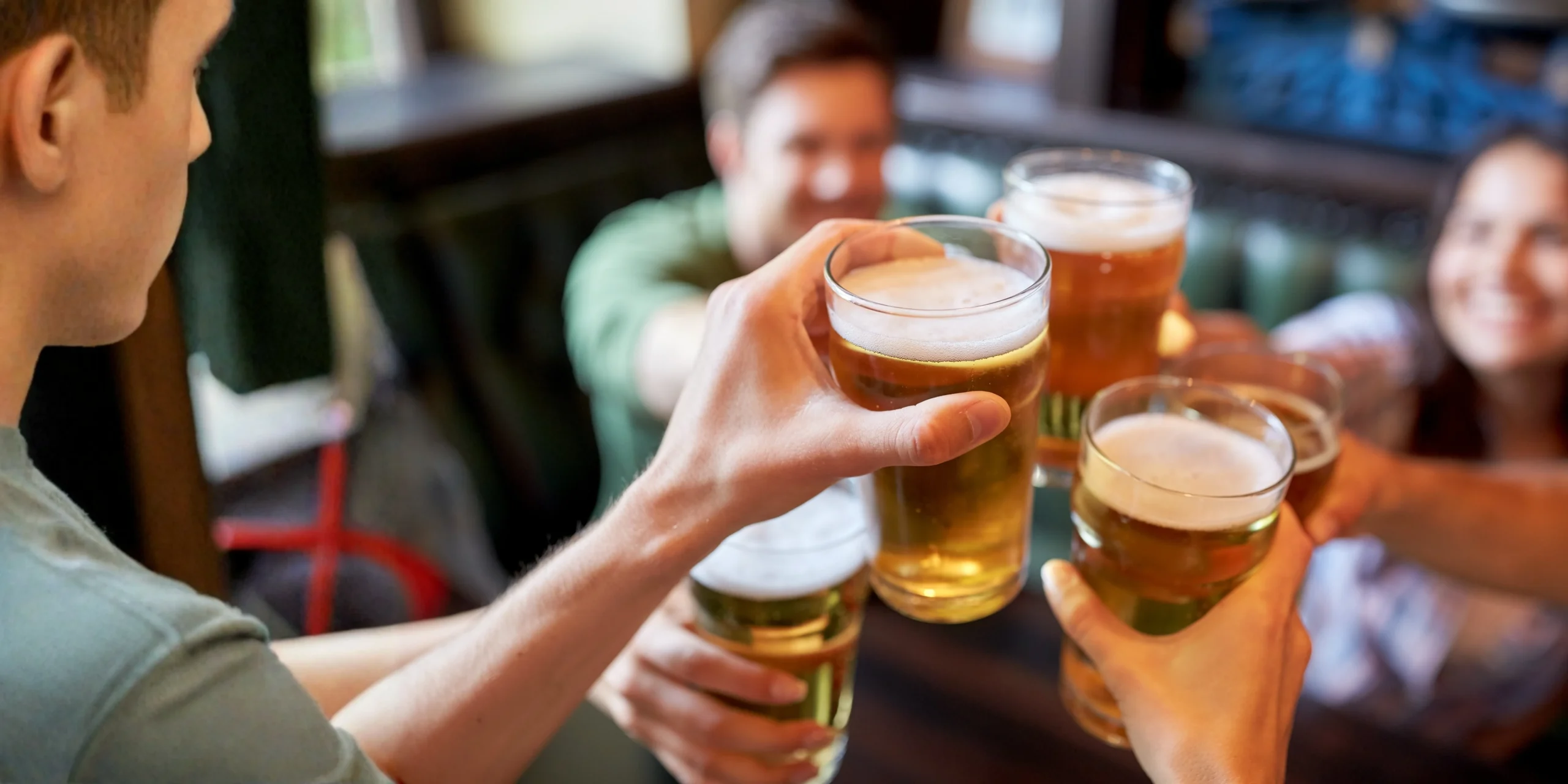 Group of friends clinking their glasses of VinBon beer together